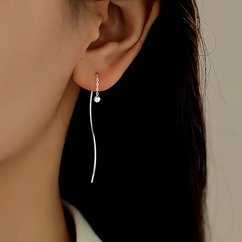 Model showcasing the dangle and style of the Sterling Silver Round Bead Threader Earrings