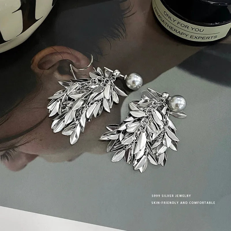 Model showcasing the dangle and style of the Sterling Silver S999 Leaf Pearl Tassel Earrings