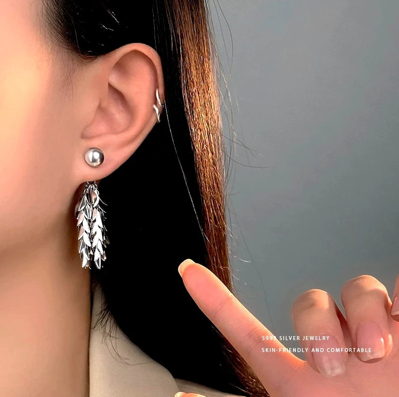 Close-up detail of the sparkling zircons and plating on the Pearl and Leaf Earrings