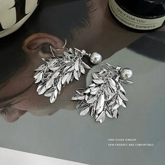 Model showcasing the dangle and style of the Sterling Silver S999 Leaf Pearl Tassel Earrings
