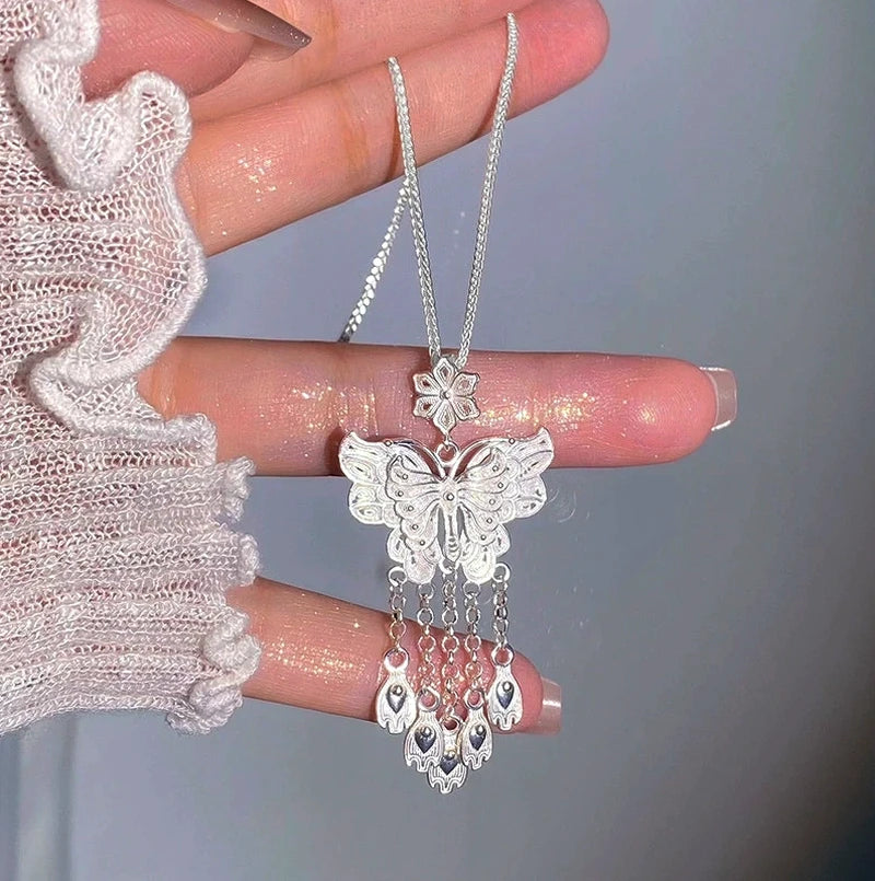 Close-up of the pendant and clasp on the Butterfly Tassel Necklace (*Correction: Handle and original tags imply necklace, not earrings*)