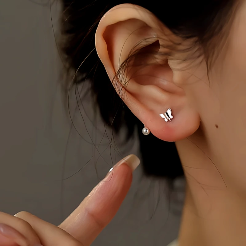 Model showcasing the dangle and style of the Sterling Silver Screw Butterfly Stud Earrings