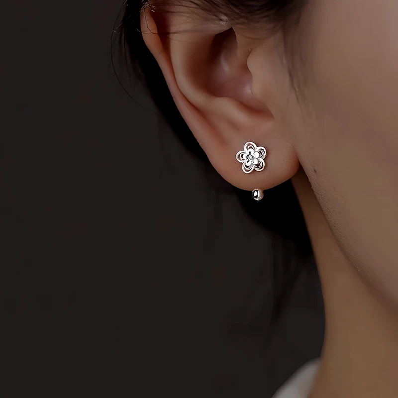 Model showcasing the dangle and style of the Sterling Silver Screw Flower Earrings