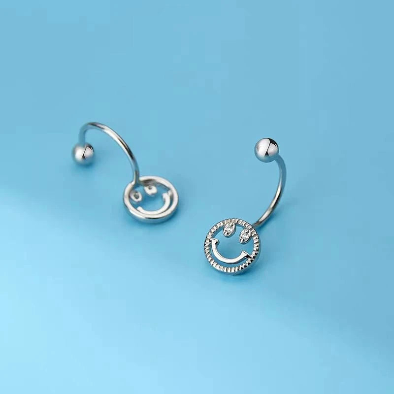 Model showcasing the dangle and style of the Sterling Silver Screw Smail Face Jacket Earrings