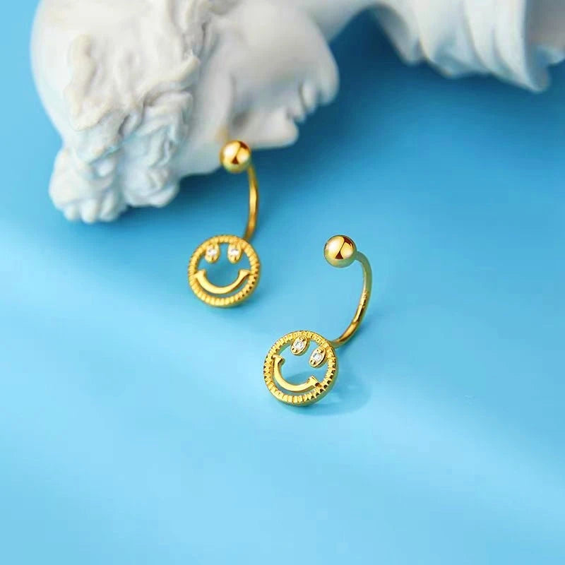 Close-up detail of the sparkling zircons and plating on the Smile Face Ear Jackets