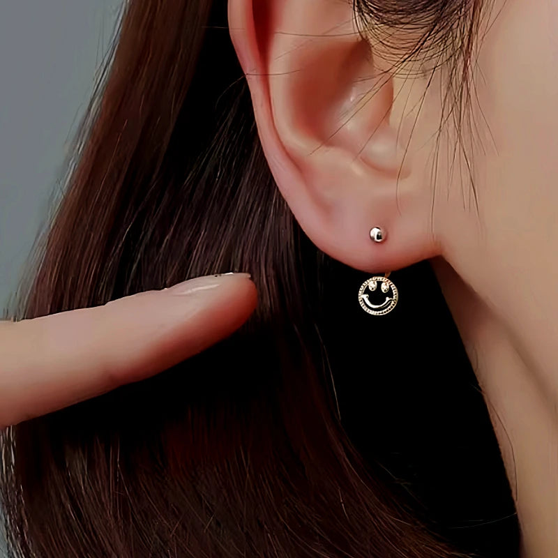 Angled view of the Sterling Silver Screw Smail Face Jacket Earrings