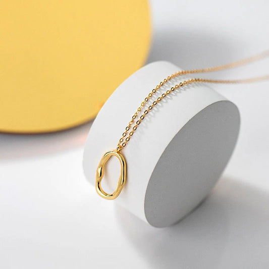 Sterling Silver Simple Geometric Oval Necklace worn to showcase its length and pendant detail