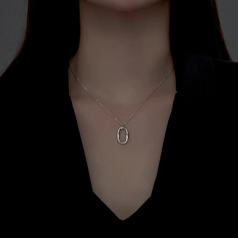 Close-up of the pendant and clasp on the Geometric Oval Necklace