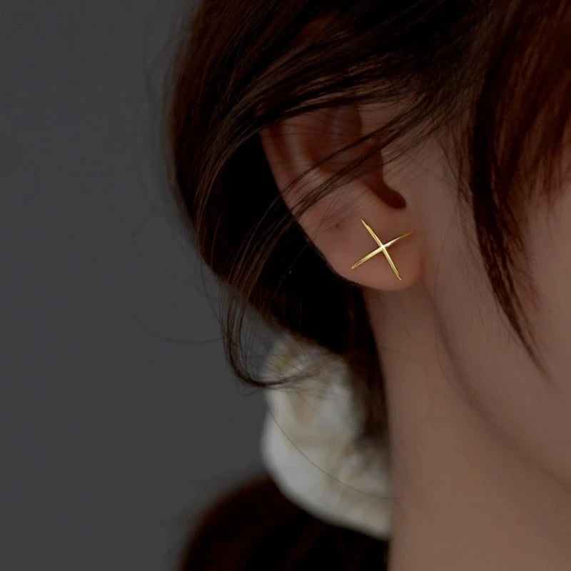 Angled view of the Sterling Silver Simple X-Shaped Stud Earrings