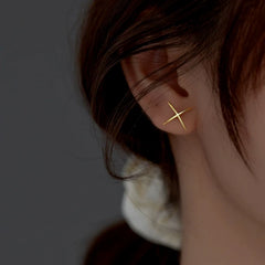 Angled view of the Sterling Silver Simple X-Shaped Stud Earrings