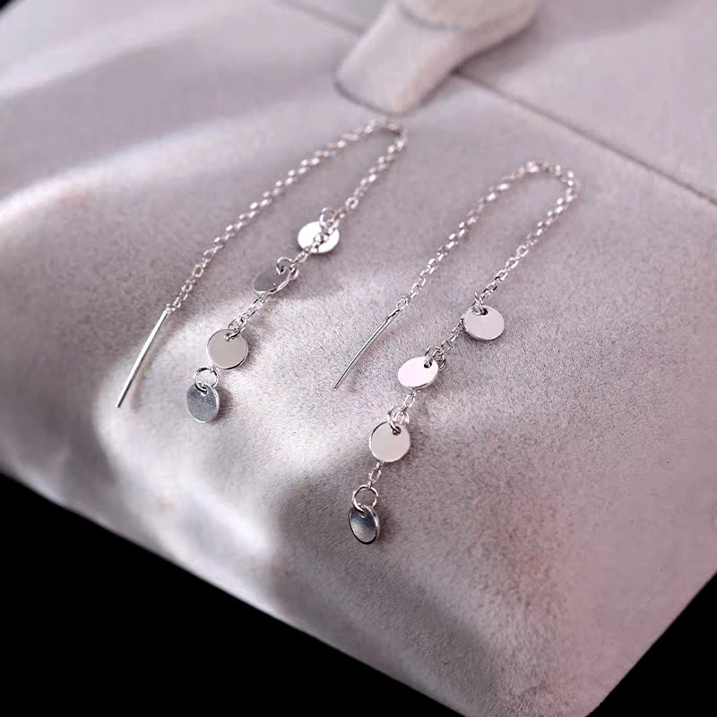 Close-up detail of the sparkling zircons and plating on the Disc Tassel Earrings