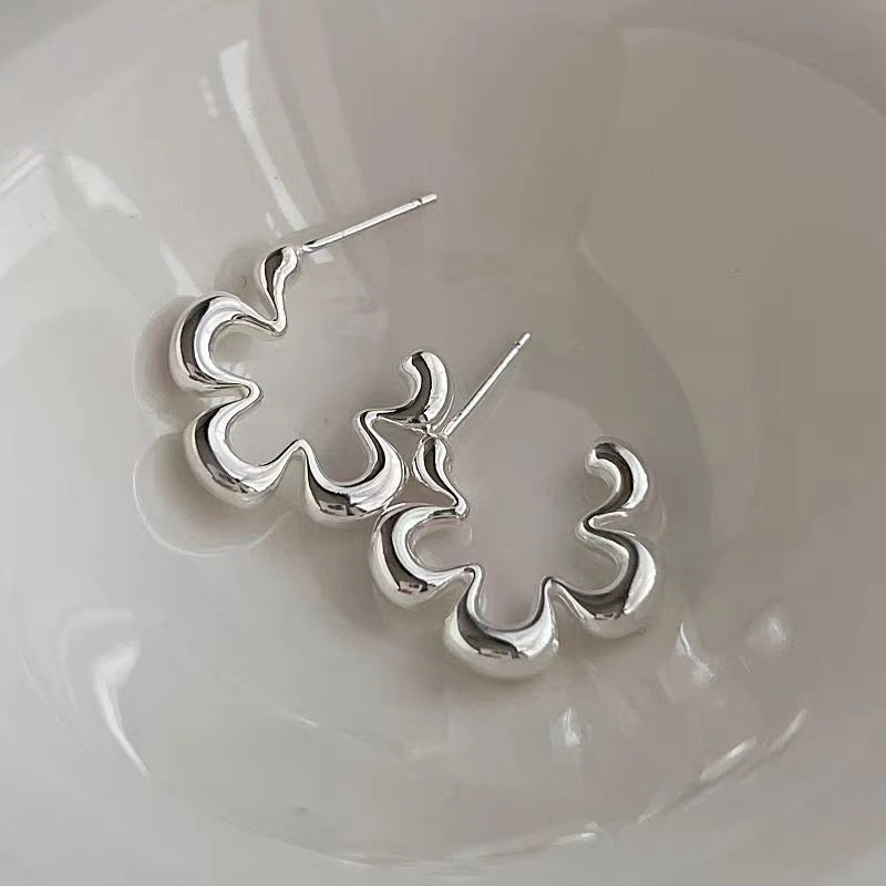 Angled view of the Sterling Silver Small Flower Earrings