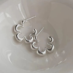 Angled view of the Sterling Silver Small Flower Earrings