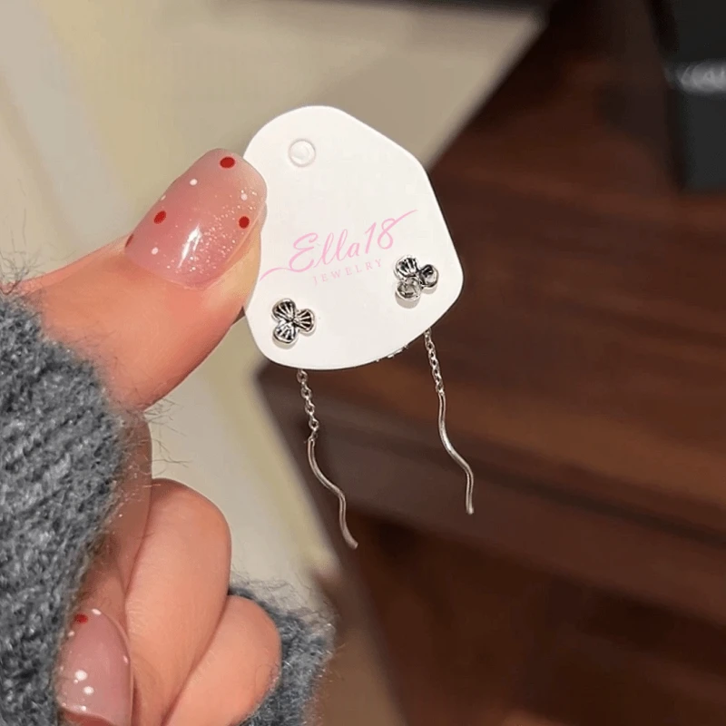 Angled view of the Sterling Silver Small Flower Threader Earrings