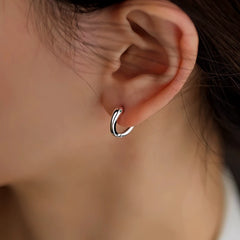 Model showcasing the dangle and style of the Sterling Silver Snake Hoop Earrings