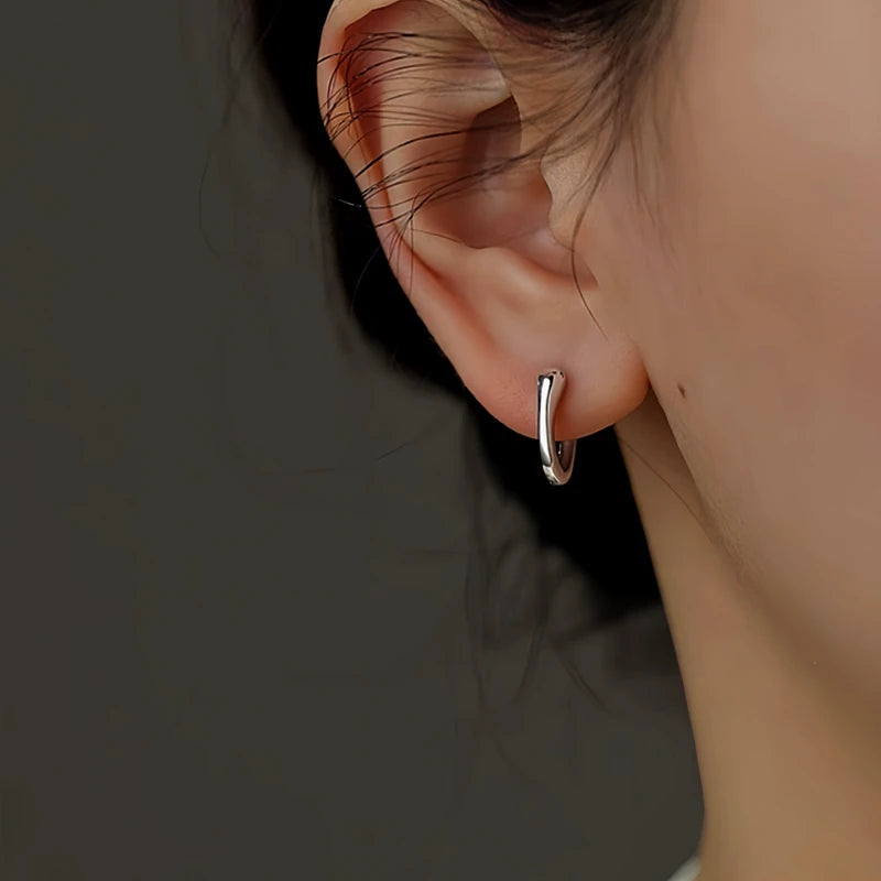 Close-up detail of the sparkling zircons and plating on the Snake Hoop Earrings