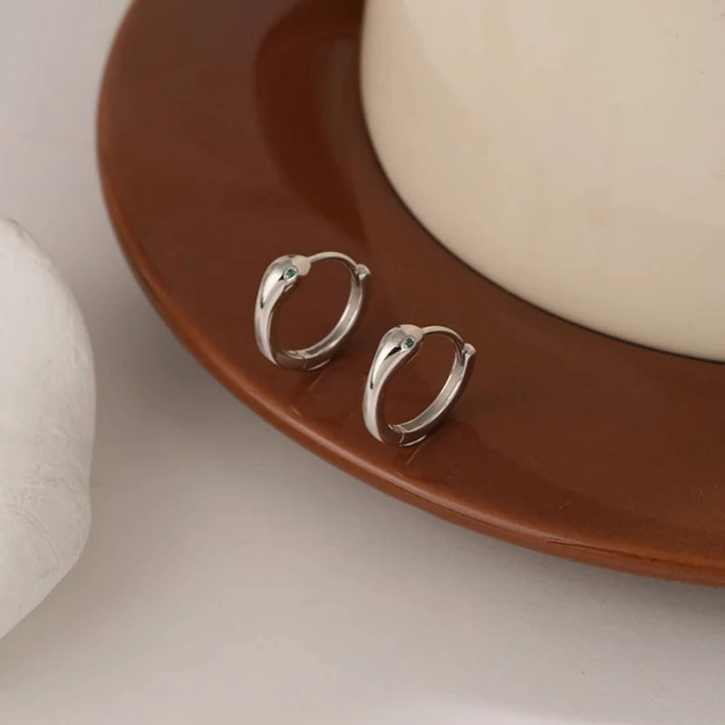 Angled view of the Sterling Silver Snake Hoop Earrings