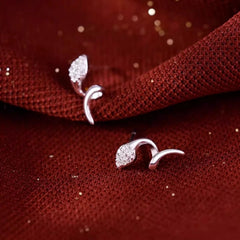Close-up detail of the sparkling zircons and plating on the Snake Stud Earrings