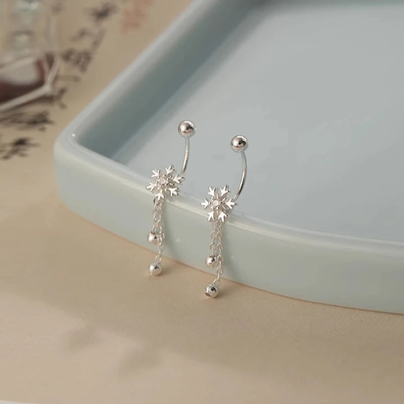 Angled view of the Sterling Silver Snowflake Jacket Earrings