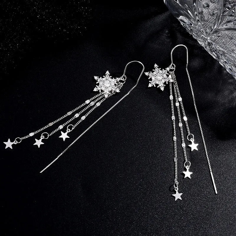 Model showcasing the dangle and style of the Sterling Silver Snowflake Star Threader Tassel Earrings