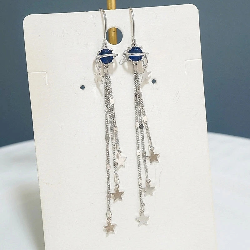 Angled view of the Sterling Silver Space Star Threader Tassel Earrings