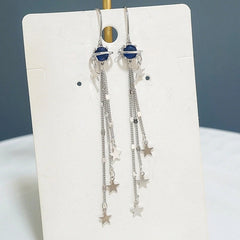 Angled view of the Sterling Silver Space Star Threader Tassel Earrings
