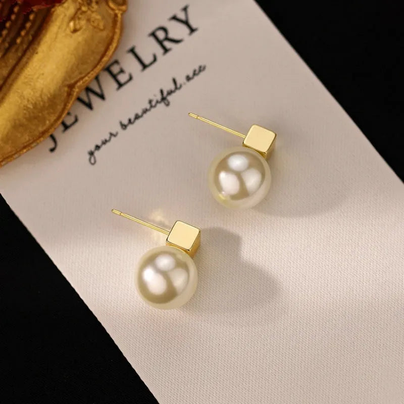 Close-up detail of the sparkling zircons and plating on the Square Pearl Studs