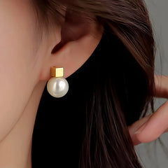 Model showcasing the dangle and style of the Sterling Silver Square Pearl Earrings