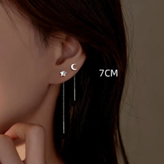Angled view of the Sterling Silver Star And Moon Threader Earrings