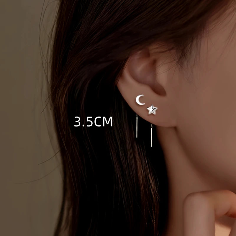 Model showcasing the dangle and style of the Sterling Silver Star And Moon Threader Earrings