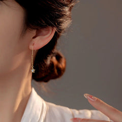 Model showcasing the dangle and style of the Sterling Silver Star Ear Hook Earrings