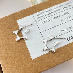 Close-up detail of the sparkling zircons and plating on the Dangling Star Earrings