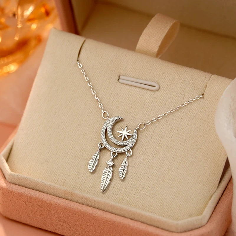 Detailed view of the Sterling Silver Star Moon Feather Necklace chain and pendant