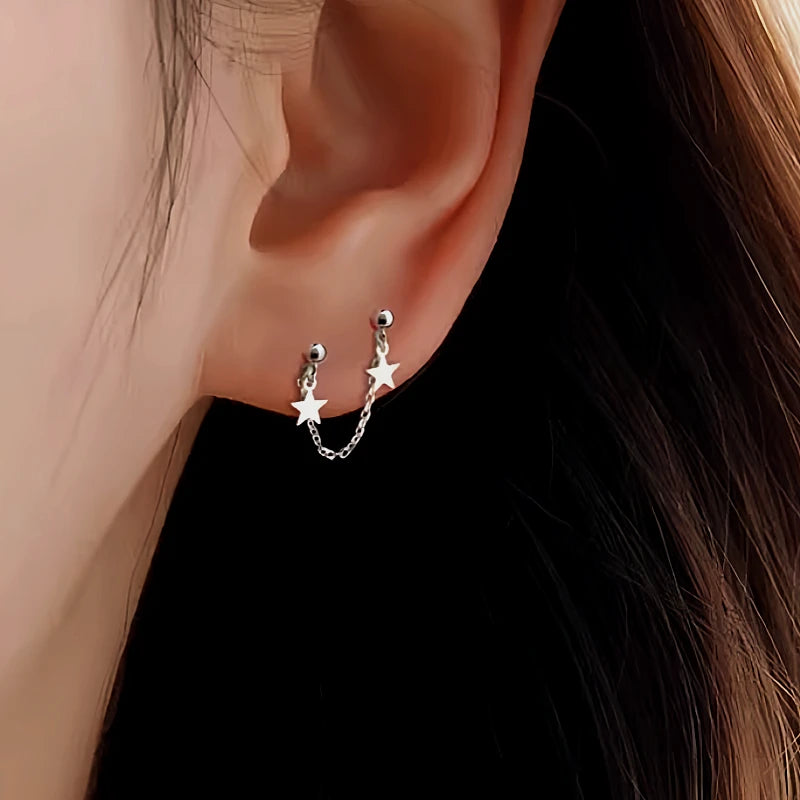 Angled view of the Sterling Silver Star Tassel Earrings