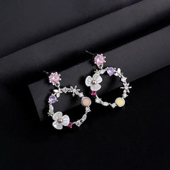 Model showcasing the dangle and style of the Sterling Silver Super Fairy Flower Earrings