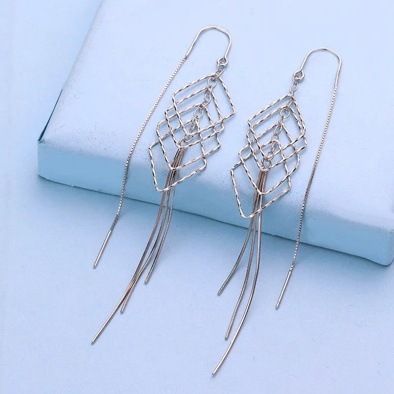 Model showcasing the dangle and style of the Sterling Silver Tassel Threader Earrings