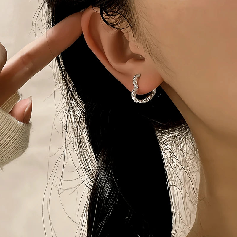 Close-up detail of the sparkling zircons and plating on the Textured Heart Earrings