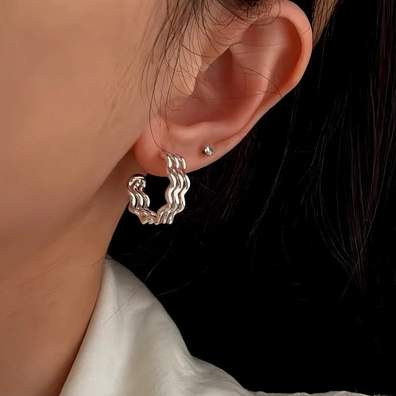 Model showcasing the dangle and style of the Sterling Silver Three-Layer Wave Texture Earrings