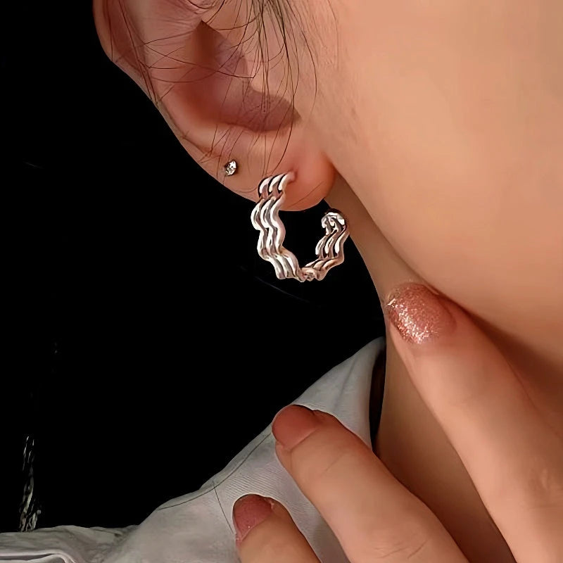 Close-up detail of the sparkling zircons and plating on the Wave Texture Earrings