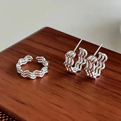 Angled view of the Sterling Silver Three-Layer Wave Texture Earrings