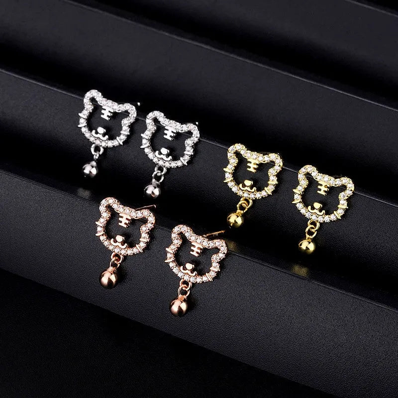 Rose gold, gold, silver crystal tiger bell stud earrings on display