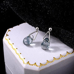 Close-up detail of the sparkling zircons and plating on the Water Drop Dangle Earrings