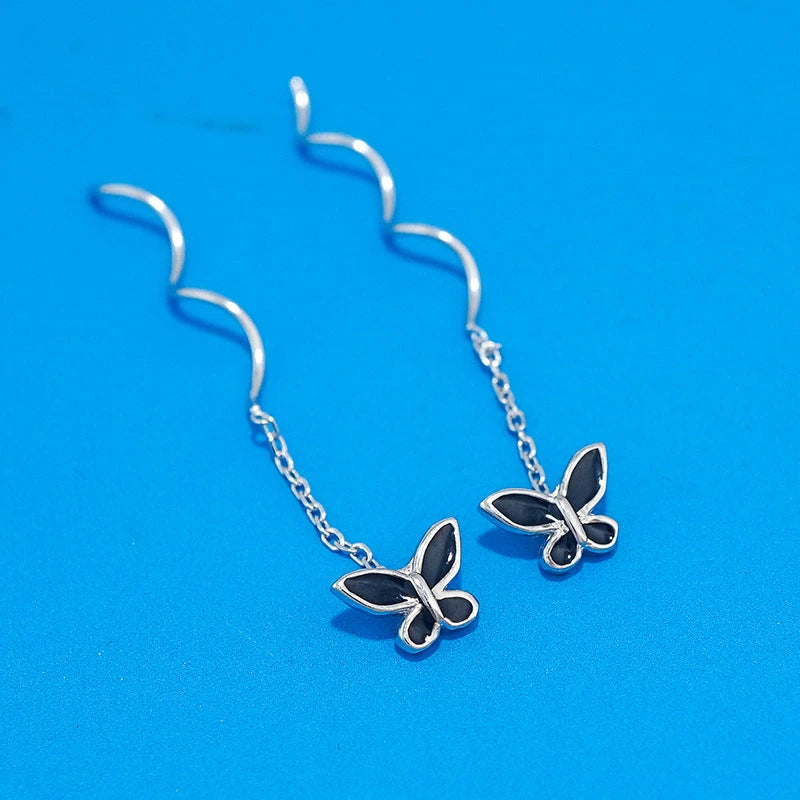Model showcasing the dangle and style of the Sterling Silver Wavy Butterfly Threader Earrings
