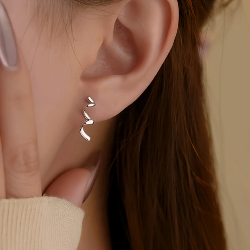 Close-up detail of the sparkling zircons and plating on the Wavy Ribbon Earrings