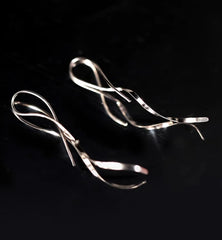 Model showcasing the dangle and style of the Sterling Silver Wavy Threader Earrings