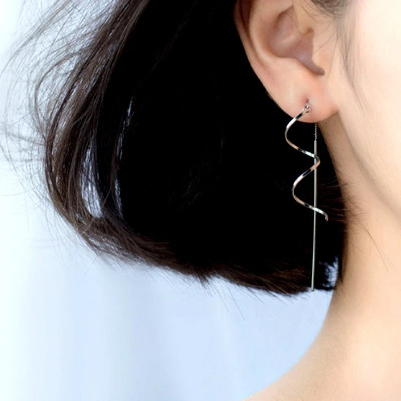 Model showcasing the dangle and style of the Sterling Silver Wavy Threader Tassel Earrings