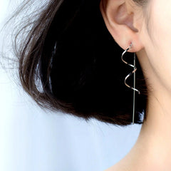 Model showcasing the dangle and style of the Sterling Silver Wavy Threader Tassel Earrings