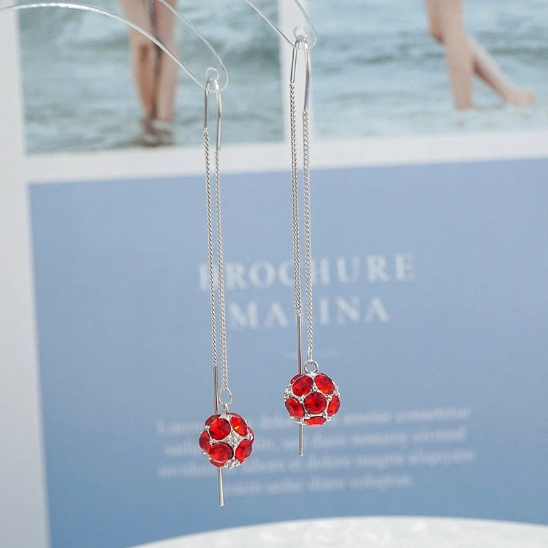 Model showcasing the dangle and style of the Sterling Silver Zircon Ball Threader Earrings