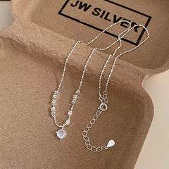 Close-up of the pendant and clasp on the Crushed Silver Necklace