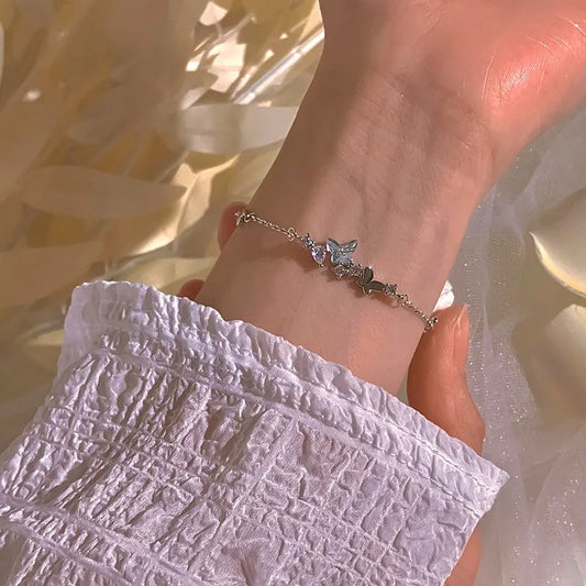 Model wearing the Sterling Silver Zircon Butterfly Bracelet to highlight its design on the wrist
